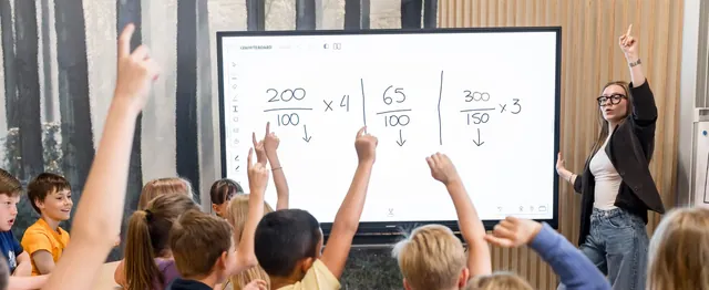 A teacher and a class working on an i3 touchscreen